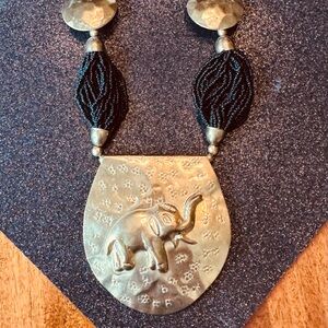 Gold and Black Necklace with Intricate Pendant Design